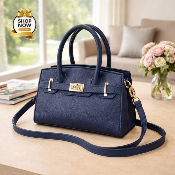 Navy blue handbag with gold accents on a table in a living room setting.