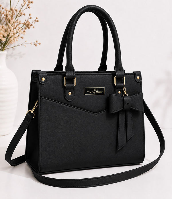Black handbag with a bow detail on a white background