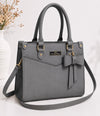 Gray handbag with a bow detail on a white background