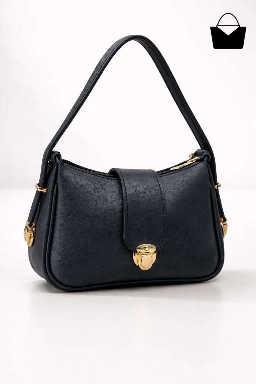 Black handbag with gold accents on a white background