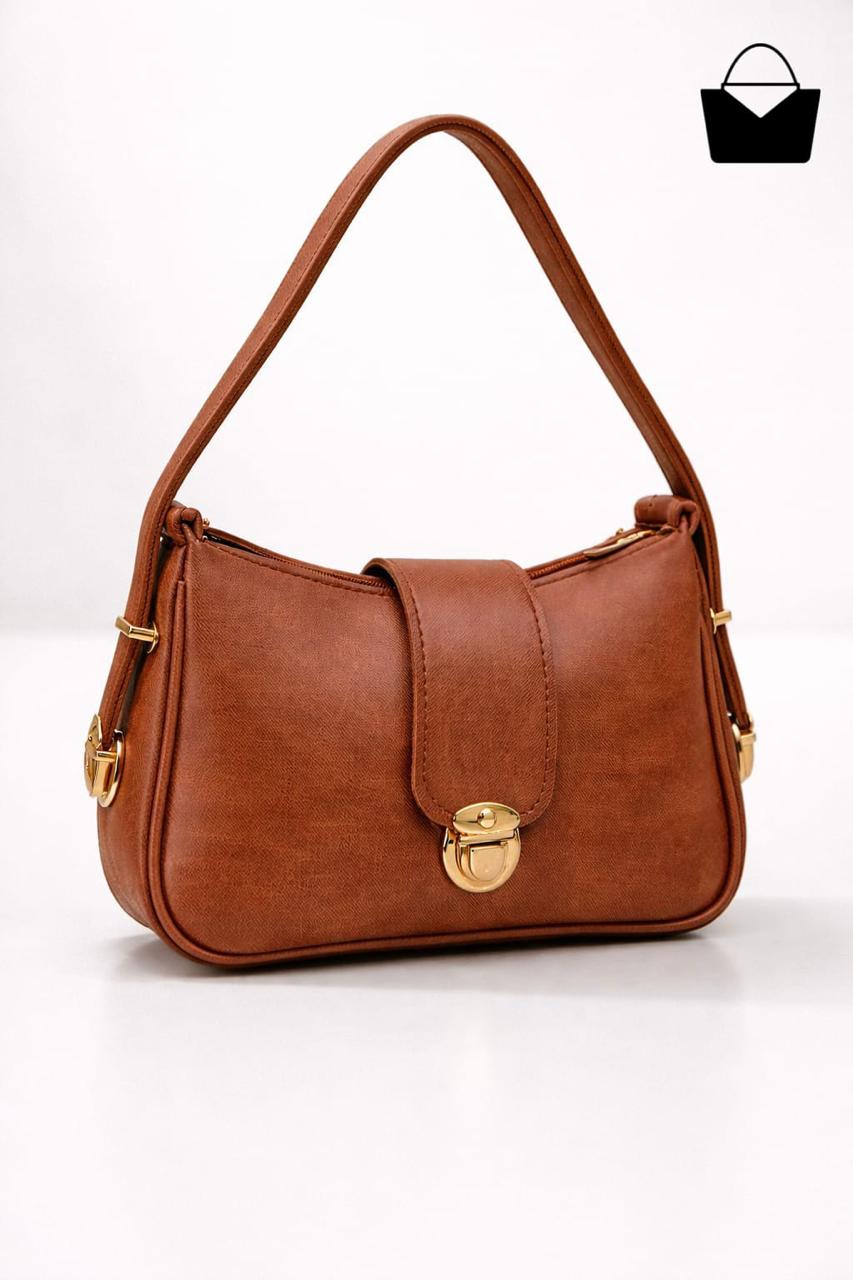 Brown handbag with a gold clasp on a white background