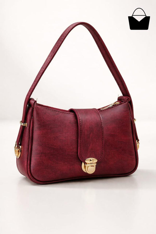 Red handbag with gold accents on a white background