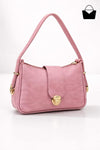 Pink handbag with gold accents on a white background
