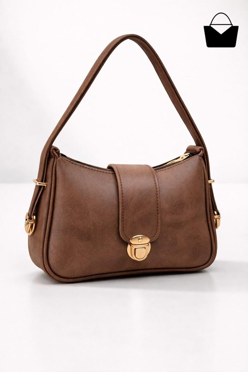 Brown handbag with gold accents on a white background
