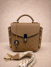 Brown handbag with decorative elements on a beige background