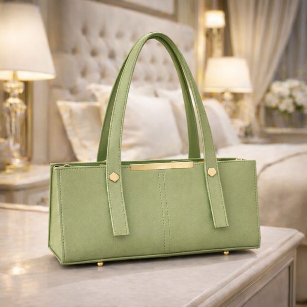 Green handbag on a table with a bedroom background