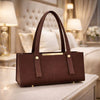 Brown handbag on a table with a blurred background
