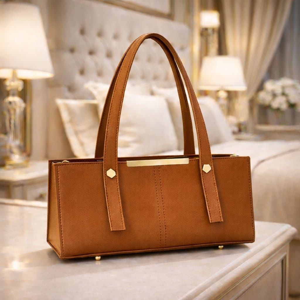 Orange handbag on a table with a blurred background
